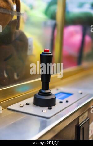 Mechanical claw game machine. Close-up view. Stock Photo