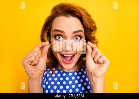 Close-up portrait of nice attractive lovely crazy cheerful cheery wavy-haired girl putting of specs expressing wow reaction isolated on bright vivid Stock Photo