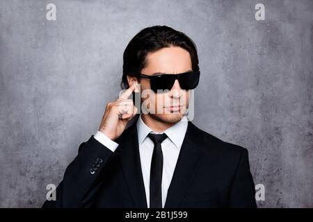 Portrait of handsome young security guard in black glasses Stock Photo