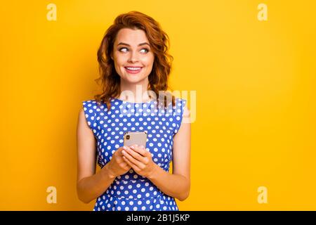 Portrait of her she nice attractive lovely girlish curious cheerful cheery wavy-haired girl using cell creating new smm isolated on bright vivid shine Stock Photo