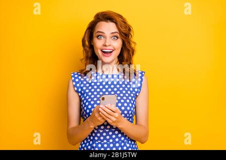Portrait of her she nice attractive lovely amazed addicted cheerful cheery wavy-haired girl using cell positive news like isolated on bright vivid Stock Photo