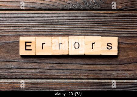 Errors word written on wood block. Errors text on wooden table for your desing, concept. Stock Photo