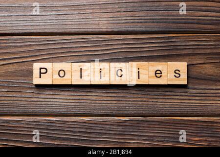 policies word written on wood block. policies text on table, concept. Stock Photo