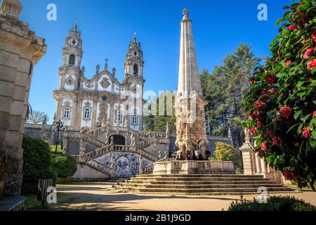 Nossa Senhora dos Remédios Sanctuary in Lamego, Portugal, with the church in the background and fountain with obelisk in the foreground, on a blue sky Stock Photo