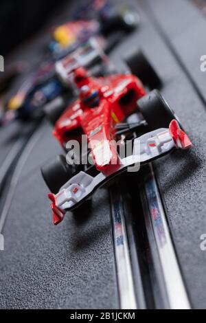 Model formula one Ferrari style slot car racing on a Scalextric track Stock Photo