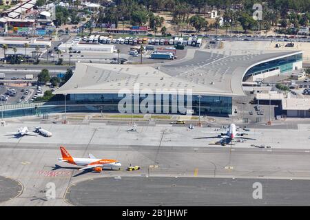 Gibraltar – July 30, 2018: Easyjet Airbus A320 airplane at Gibraltar airport (GIB) with Terminal. Airbus is a European aircraft manufacturer based in