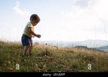 Small kid in spring mountains. Travel with child concept Stock Photo