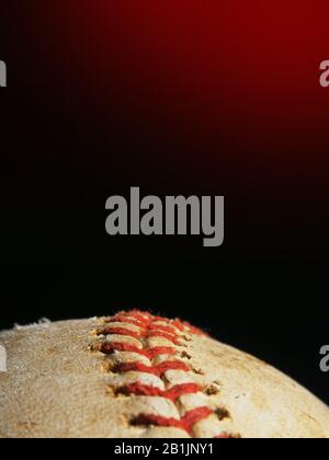 Old used baseball macro over black background with copyspace, vertical layout Stock Photo