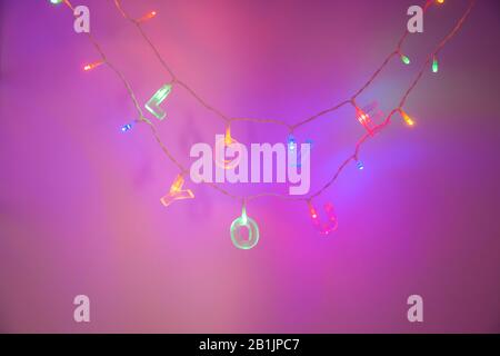 love you letters on a string of lights with purple neon light background Stock Photo