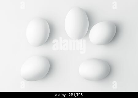 Flat lay five white chicken eggs on a white background with copy space Stock Photo