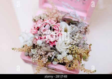 Wedding decorations. Rings lie on the flowers Stock Photo