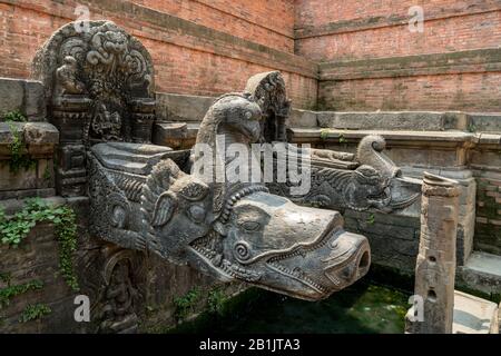 Stone water spouts of Manga Hiti at Durbar Square in Lalitpur (Patan), Kathmandu valley, Nepal Stock Photo