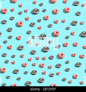Donut seamless pattern. Blue background. Pink and chocolate sweets Stock Photo
