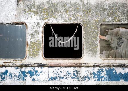 Broken window on derelict Royal Iris ferry boat Stock Photo