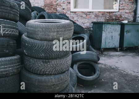 pile of old tire . used tires at the dumpster Stock Photo