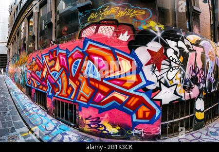 Brightly coloured geometric designed graffiti in cobbled stone  back alleywayHosier Street, Melbourne Lanes, Melbourne, Victoria, Australia Stock Photo