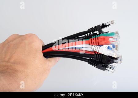 Hand holding ethernet network cables connectors Stock Photo
