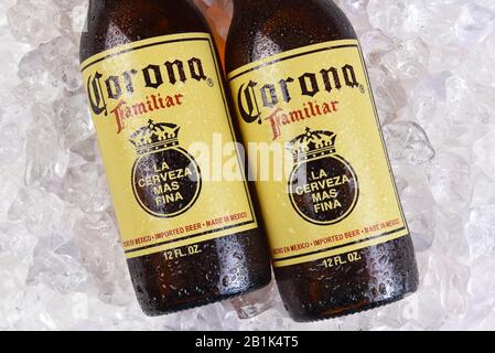 IRVINE, CALIFORNIA - MARCH 21, 2018: Two Corona Familiar beer bottles on ice. Familiar tastes like Corona Extra, but with a richer flavor. Stock Photo
