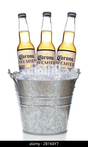 IRVINE, CALIFORNIA - MARCH 21, 2018:  Three Corona Premier Bottles in an Ice Bucket with Condensation isolated on white vertical composition with refl Stock Photo