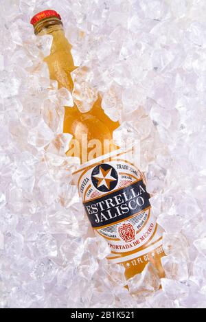 IRVINE, CALIFORNIA - MARCH 29, 2018: Closeup of a bottle of Estrella Jalisco beer in ice.  Estrella Jalisco is a American Lager style beer brewed by G Stock Photo