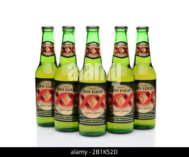 IRVINE, CA - MAY 27, 2014: Five Bottles of Dos Equis Lager Especial on white with reflection. Founded in 1890 from the Cuauhtemoc-Moctezuma Brewery in Stock Photo