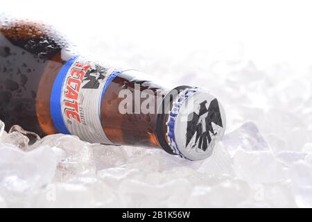 IRVINE, CA - JUNE 14, 2017: Tecate Light bottle on Ice.  A bottle of Tecate Light, a popular pale lager named after the city of Tecate, Baja Californi Stock Photo