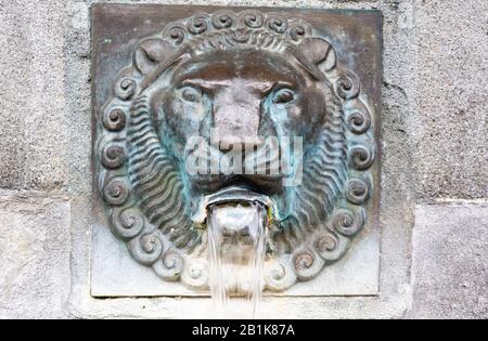 Lucerne, Switzerland - June 26, 2016. Historic fountain in Lucerne, with water pouring out of lion’s mouth. Stock Photo