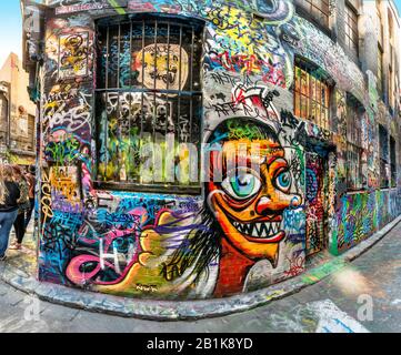 Funny face graffiti painted on brick wall down an alley full of colourful graffiti, Hosier Street, Melbourne Lanes, Melbourne, Victoria, Australia Stock Photo
