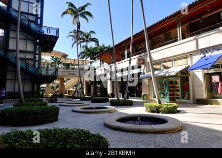 A few people in a paved, courtyard area of the Shops at Merrick Park, an upscale outdoor mall in Coral Gables, Miami, Florida, USA. Stock Photo