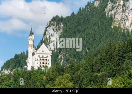 Fussen, Germany – June 29, 2016. Exterior view of Schloss Neuschwanstein castle in Hohenschwangau village near Fussen, with mountains in the backdrop. Stock Photo