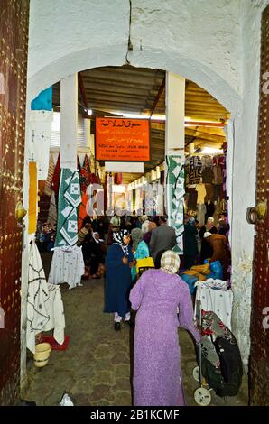 Meknes, Morocco - November 19th 2014: Unidentified people in the narrow ways of the carpet souk with different shops Stock Photo