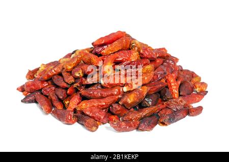 Pile dried Cayenne pepper isolated on white background. Also called Guinea spice, cow-horn pepper, aleva, bird pepper,  red pepper, hot chili pepper. Stock Photo