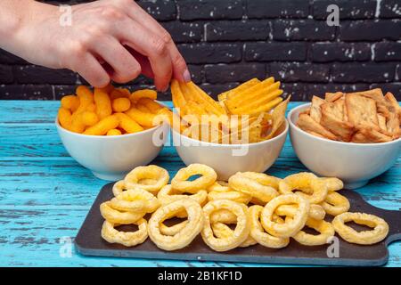 Differnt Types of Junk food, salty-sticks, salty-crackers on wooden table in still-life Stock Photo