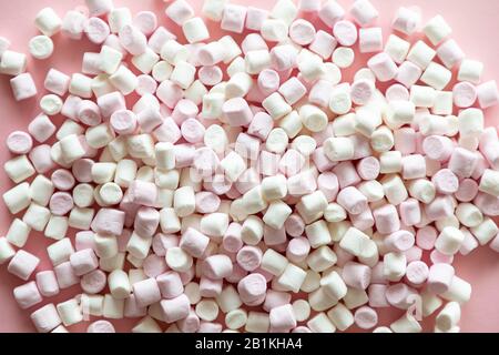 Background or texture of pink and white mini marshmallows on pink background Stock Photo