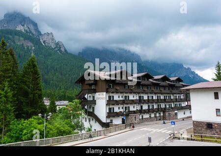 San Martino di Castrozza, Trentino, Italy – July 3, 2016. Street view in San Martino di Castrozza mountain resort in Italy, with Hotel Colfosco and th Stock Photo