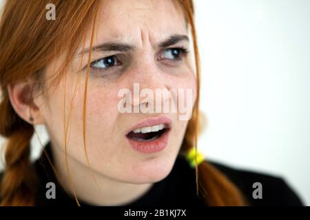 Close up portrait of angry redhead teenage girl. Stock Photo