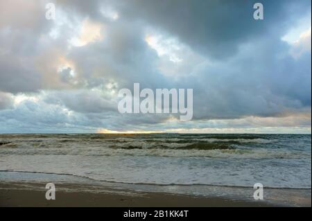 Baltic sea coast, small waves on the sea, ships on the sea horizon Stock Photo