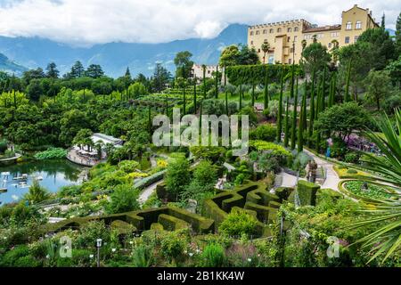 Merano, South Tirol, Italy – July 4, 2016. View of terraced botanical gardens and Trauttmansdorff Castle in Merano, Italy. View with people in summer. Stock Photo