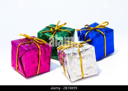 Four gift boxes with golden ribbon isolated on white Stock Photo