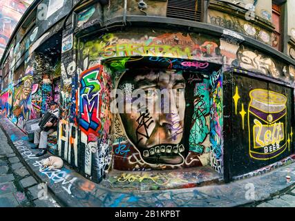 Elderly man playing piano accordian with dog, busking in graffiti filled cobbled stone alleyway, Hosier Street, Melbourne Lanes, Melbourne, Victoria, Stock Photo