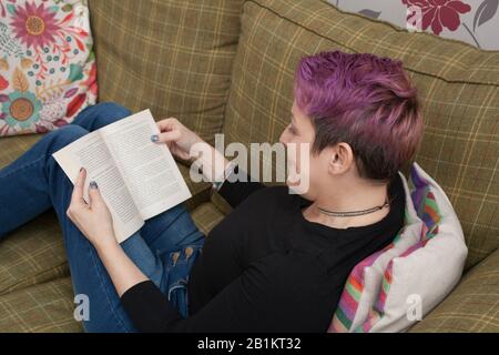 A woman reading a book about affirmations Stock Photo