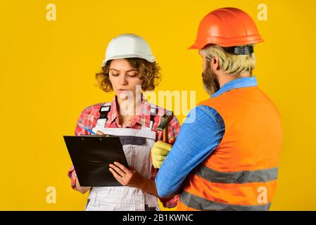work at construction site or factory. Civil engineering. industrial business partner. job and occupation. confident electrical and technician. engineers couple working together on building blueprint. Stock Photo