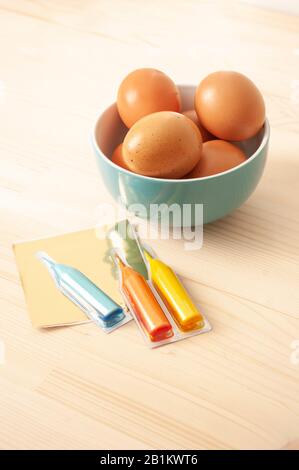 Easter eggs paint, blue ceramic bowl, catholic, orthodox holiday. Easter 2020. Church christian celebration. Stock Photo