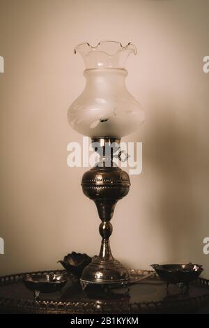 Vintage table glass lamp on round coffee table, retro film edit Stock Photo