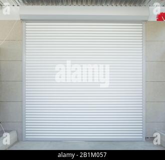 Automatic Electric Roll-up Gate Or Push-up Door In The Modern Building Ground Floor . Shutter door or roller door and concrete floor outside .White Au Stock Photo