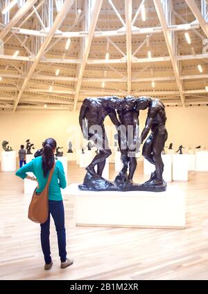 Adult looking at sculptureThe Three Shades by Aguste Rodin in the Soumaya Museum, Polanco, Mexico City, Mexico Stock Photo