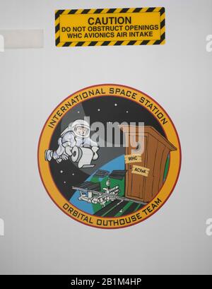 A humorous decal above the toilet facility in Node 3 of the International Space Station (ISS) at NASA's full-size mockup of the ISS at the Johnson Space Center. Stock Photo