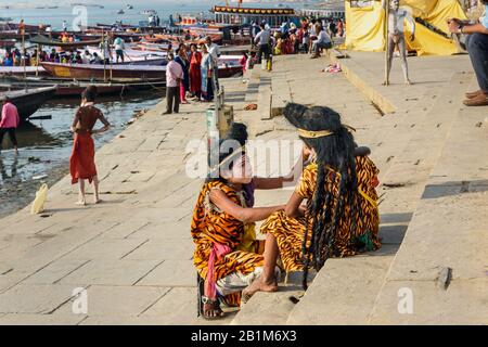 Indian girls dressed like Shiva near Ganga river at Dashashwamedh Ghat in Varanasi. India Stock Photo