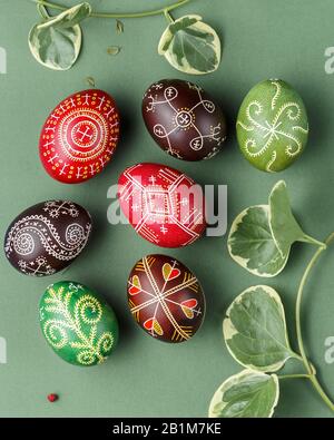 Pysanky, Ukrainian Easter eggs decorated with wax-resist dyeing technique on green background Stock Photo
