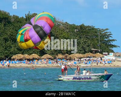 Holiday makers taking part in parasailing in Puerto Plata, Dominican Republic Stock Photo